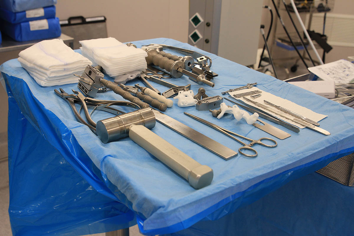  3D-printed knee guides on a tray along with other surgical tools in preparation for an operation. 