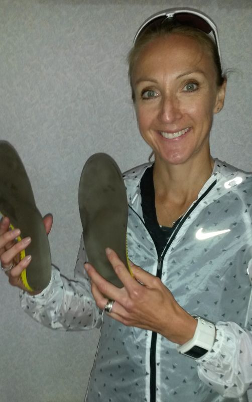 Paula Radcliffe holds a pair of her 3D-printed phits orthotics 