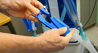 Doctor attaching 3D printed ventilator valve